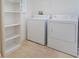 Laundry room with washer, dryer, and shelving at 560 Presido Park Pl, Kissimmee, FL 34759