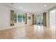 Bright living room with tile floors, sliding glass doors, and neutral color palette at 560 Presido Park Pl, Kissimmee, FL 34759