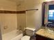 Bathroom with granite vanity, glass sink, and a tub shower at 6106 Westgate Dr # 103, Orlando, FL 32835