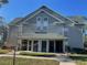 Two-story building exterior, gray siding, and a covered entryway at 6106 Westgate Dr # 103, Orlando, FL 32835