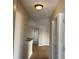 Hallway with light walls, wood-look flooring, and access to other rooms at 6106 Westgate Dr # 103, Orlando, FL 32835