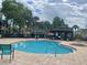 Community pool with a gazebo and lounge chairs at 6106 Westgate Dr # 103, Orlando, FL 32835