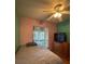 Bedroom with wood floors, ceiling fan, and sliding glass doors at 6133 Olympic Ct, Orlando, FL 32808