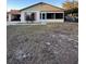 Ranch-style home with screened porch and carport at 6133 Olympic Ct, Orlando, FL 32808