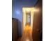 Home hallway with light walls and wood flooring at 6133 Olympic Ct, Orlando, FL 32808