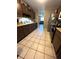 Eat-in kitchen with dark wood cabinets and tiled floor at 6133 Olympic Ct, Orlando, FL 32808