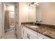 Guest bathroom with single vanity and granite countertop at 6228 Lecco Way, Windermere, FL 34786