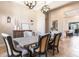 Elegant dining room featuring a rustic table, neutral decor, and natural light at 6228 Lecco Way, Windermere, FL 34786