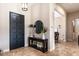 Bright and airy entryway with dark wood console table and mirror at 6228 Lecco Way, Windermere, FL 34786