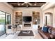 Open living room featuring a stone fireplace and built-in shelving at 6228 Lecco Way, Windermere, FL 34786