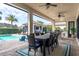 Outdoor dining area with pool view and ceiling fans at 6228 Lecco Way, Windermere, FL 34786