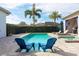 Relaxing pool area with blue chairs and spa at 6228 Lecco Way, Windermere, FL 34786