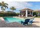 Resort-style pool with spa, covered patio, and lounge chairs at 6228 Lecco Way, Windermere, FL 34786