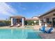 Luxury pool with adjacent spa, covered patio, and lounge chairs at 6228 Lecco Way, Windermere, FL 34786