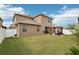 Large backyard with grassy area, two story home and a wooden pergola at 648 Cortona Dr, Orlando, FL 32828