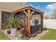 Covered patio with seating area, fire pit, and tropical plants at 648 Cortona Dr, Orlando, FL 32828