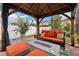 Relaxing backyard patio with covered seating area, fire pit, and lush landscaping at 648 Cortona Dr, Orlando, FL 32828
