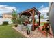 Outdoor patio features a pergola, seating area, fire pit, and tropical plants at 648 Cortona Dr, Orlando, FL 32828
