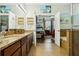Bathroom with granite countertop, double sinks, and a view of the bedroom at 648 Cortona Dr, Orlando, FL 32828