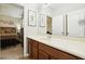 Bathroom with wood cabinets, a large mirror, and a view of a bedroom at 648 Cortona Dr, Orlando, FL 32828