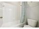 Simple bathroom with a shower/tub combo, toilet and white tile at 648 Cortona Dr, Orlando, FL 32828