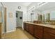 Double vanity bathroom with granite countertops and a shower at 648 Cortona Dr, Orlando, FL 32828