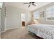 Bright bedroom with carpet flooring, ceiling fan, and en-suite bathroom at 648 Cortona Dr, Orlando, FL 32828