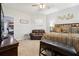 Primary bedroom with king-size bed, loveseat, and a view of another room at 648 Cortona Dr, Orlando, FL 32828