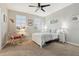 Bright bedroom with a white bed frame and wicker rocking chair at 648 Cortona Dr, Orlando, FL 32828