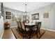Bright dining room featuring a large wooden table and six chairs, complemented by a chandelier at 648 Cortona Dr, Orlando, FL 32828