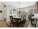 Bright dining room with a wooden table, six chairs, and decorative wall art at 648 Cortona Dr, Orlando, FL 32828