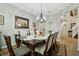 Formal dining room with a dark wood table, six upholstered chairs, and a large mirror at 648 Cortona Dr, Orlando, FL 32828