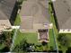 Aerial view of home with a well manicured lawn, patio gazebo, and privacy fence in the backyard at 648 Cortona Dr, Orlando, FL 32828