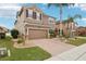Two-story house with brown exterior, brick driveway, and landscaping at 648 Cortona Dr, Orlando, FL 32828
