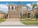 Two-story house with brown exterior, brick driveway, and landscaping at 648 Cortona Dr, Orlando, FL 32828