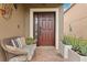 Inviting front porch with wicker seating and potted plants at 648 Cortona Dr, Orlando, FL 32828