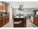 Modern kitchen featuring a large island, stainless steel appliances, and dark wood cabinets at 648 Cortona Dr, Orlando, FL 32828