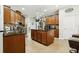 Spacious kitchen with a large island, dark wood cabinets, and granite countertops at 648 Cortona Dr, Orlando, FL 32828