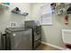 Laundry room with washer, dryer, and shelving at 648 Cortona Dr, Orlando, FL 32828