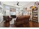 Spacious living room with a brown leather sectional sofa and hardwood floors at 648 Cortona Dr, Orlando, FL 32828