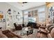 Open living room with brown leather sectional and a glass coffee table at 648 Cortona Dr, Orlando, FL 32828
