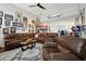 Spacious living area with a brown leather sectional and hardwood floors at 648 Cortona Dr, Orlando, FL 32828
