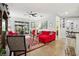 Bright living room with red sectional sofa and a large TV at 648 Cortona Dr, Orlando, FL 32828