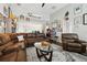 Gathering room with sectional sofa, hardwood floors and a surfboard above the fireplace at 648 Cortona Dr, Orlando, FL 32828
