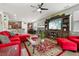 Bright living room with red sectional sofa and a large TV at 648 Cortona Dr, Orlando, FL 32828