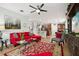 Open living room showcasing a red sectional sofa, kitchen view, and a large area rug at 648 Cortona Dr, Orlando, FL 32828