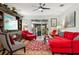 Bright living room with red sectional sofa and a large TV at 648 Cortona Dr, Orlando, FL 32828