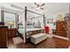 Main bedroom with canopy bed, hardwood floors, and a ceiling fan at 648 Cortona Dr, Orlando, FL 32828