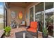 Cozy screened porch with wicker furniture and a small fountain at 648 Cortona Dr, Orlando, FL 32828