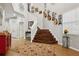 Grand staircase with dark wood risers and a red accent cabinet at 648 Cortona Dr, Orlando, FL 32828